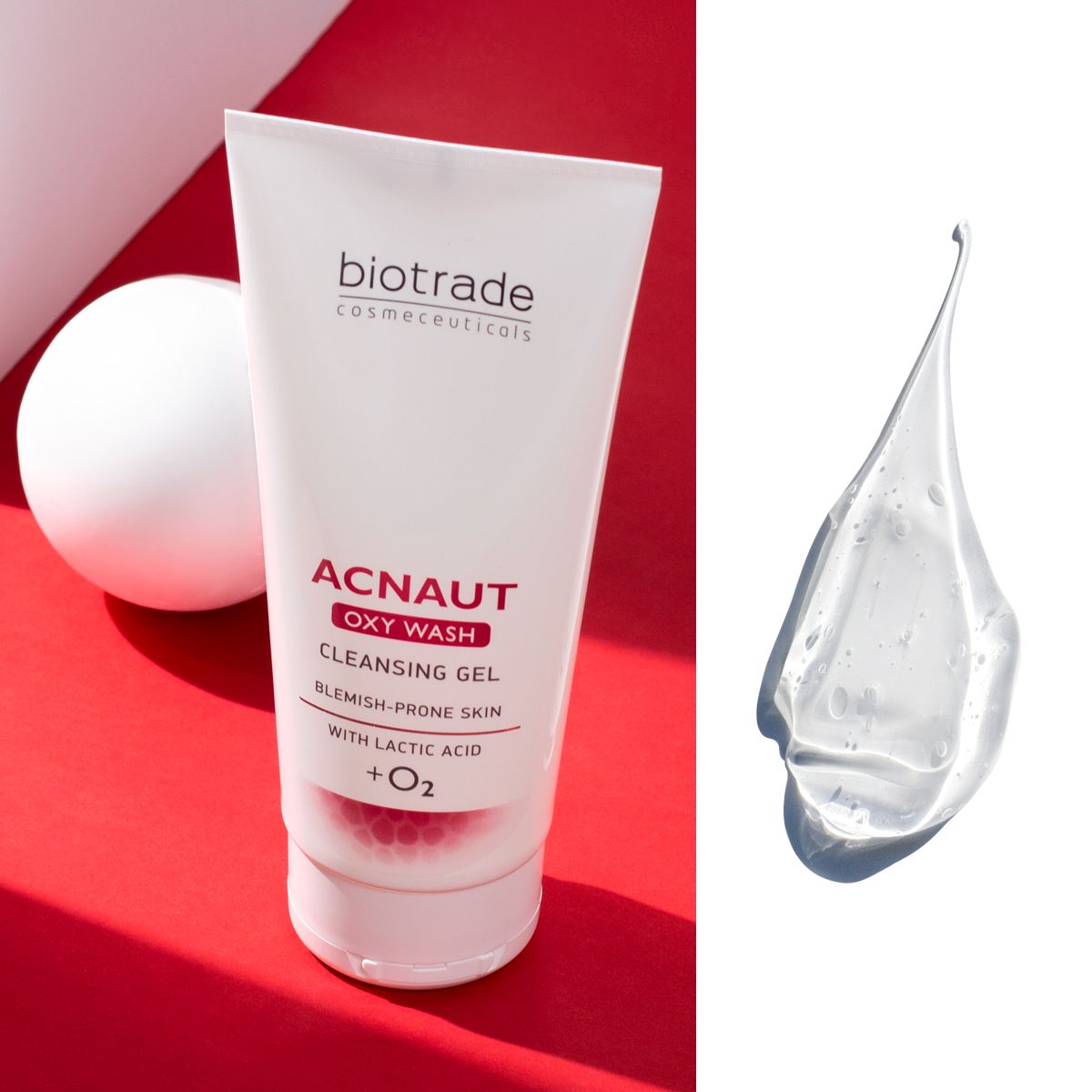 Tubo bianco con testo rosso e nero. ACNAUT OXY WASH CLEANSING GEL. Per pelli a tendenza acneica. Con acido lattico + O2. Marchio: Biotrade. Goccia di gel.