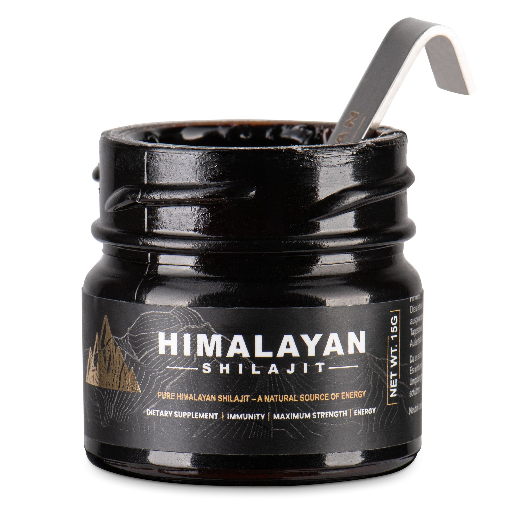 Vasetto nero di Shilajit. Cucchiaio dosatore nel vasetto. Scritta: Himalayan Shilajit. Etichetta con informazioni sul prodotto.