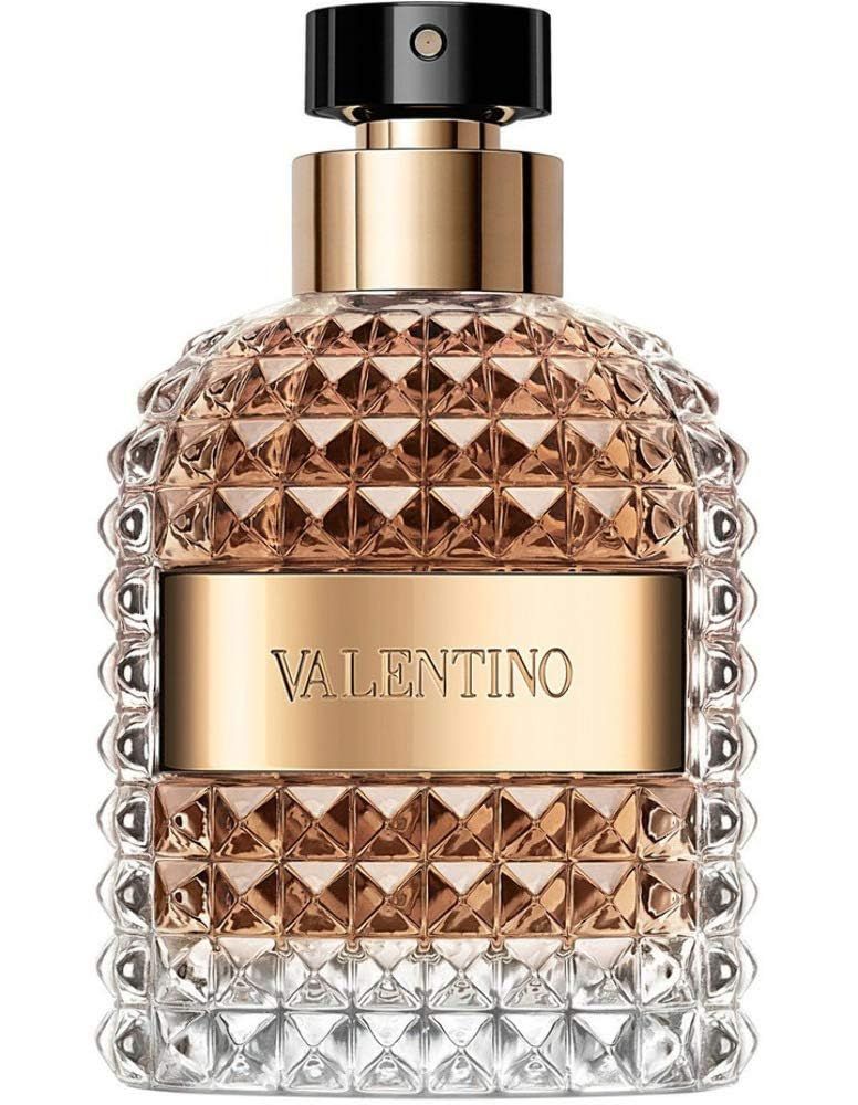 Flacone di profumo con elementi dorati e vetro goffrato. Scritta Valentino. Su sfondo bianco.