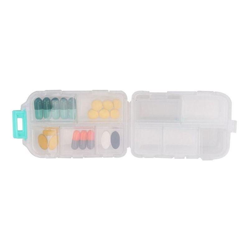 Portapillole aperto a 7 scomparti, riempito con pillole e capsule.