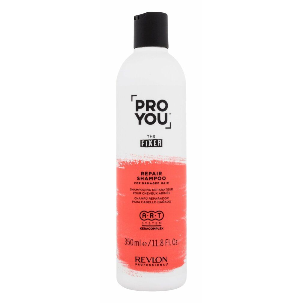 Flacone bianco con tappo nero. Scritta: PRO YOU THE FIXER REPAIR SHAMPOO. Area colorata rossa. Revlon Professional.