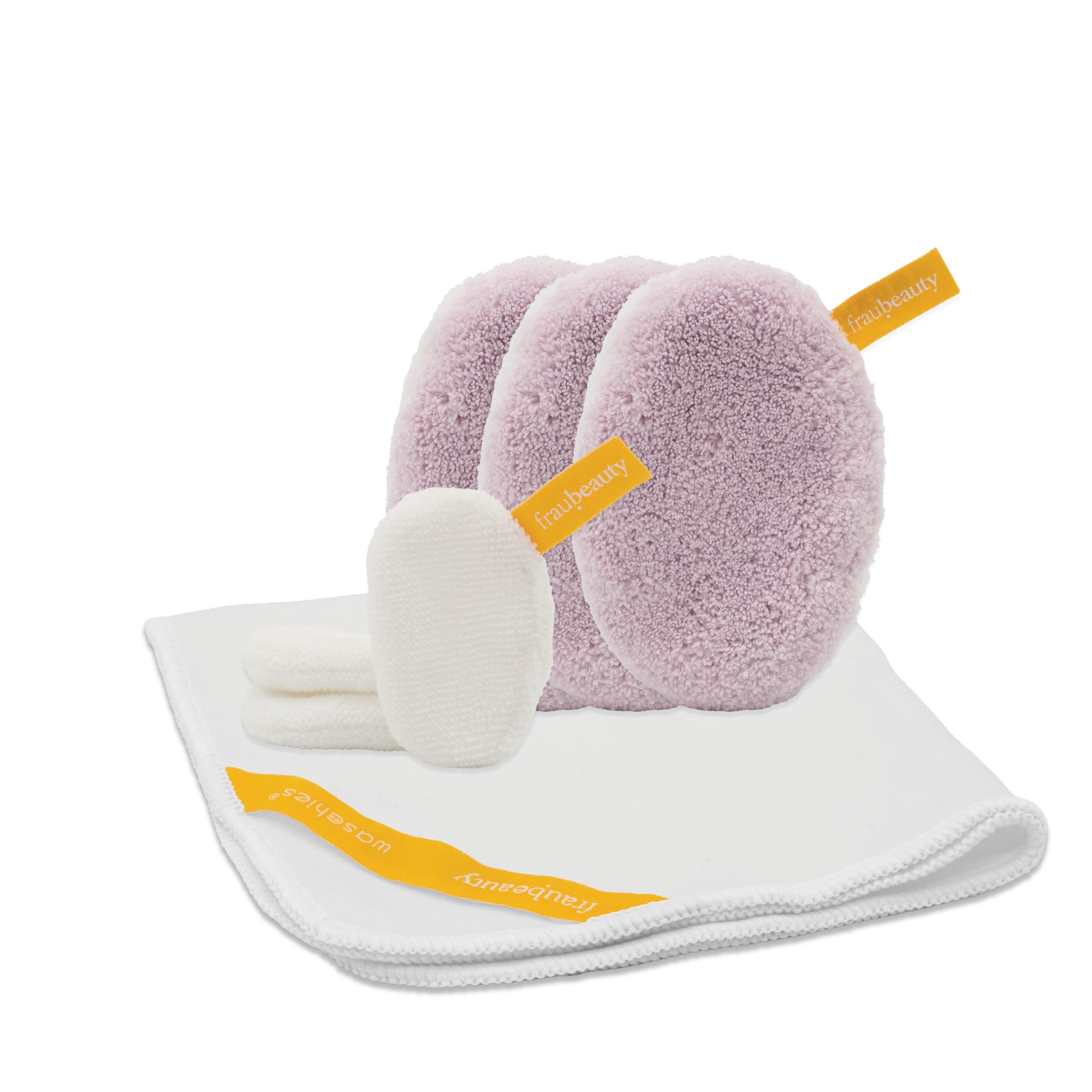 Waschies di fraubeauty, viola e bianchi. Waschies con etichette gialle. Un panno bianco. Diversi waschies e panni.