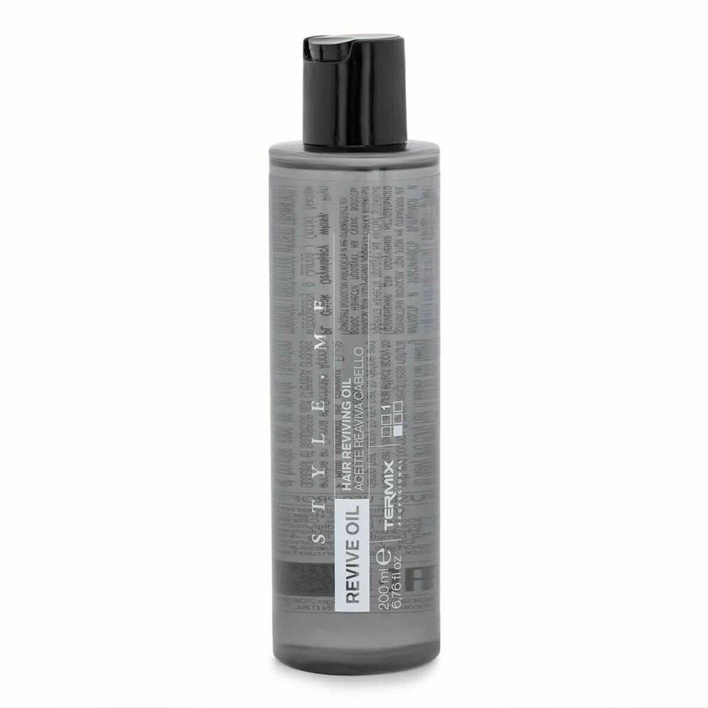 Flacone cilindrico con tappo nero. Scritte: REVIVE OIL, STYLE.ME, TERMIX. Liquido grigio visibile.