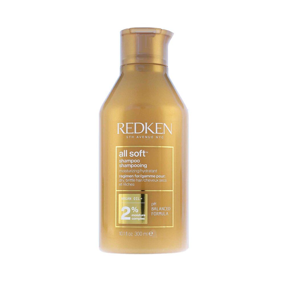 Flacone di shampoo dorato. Scritta: Redken, all soft shampoo. Contiene olio di argan e complesso idratante al 2%. Formula pH bilanciata.