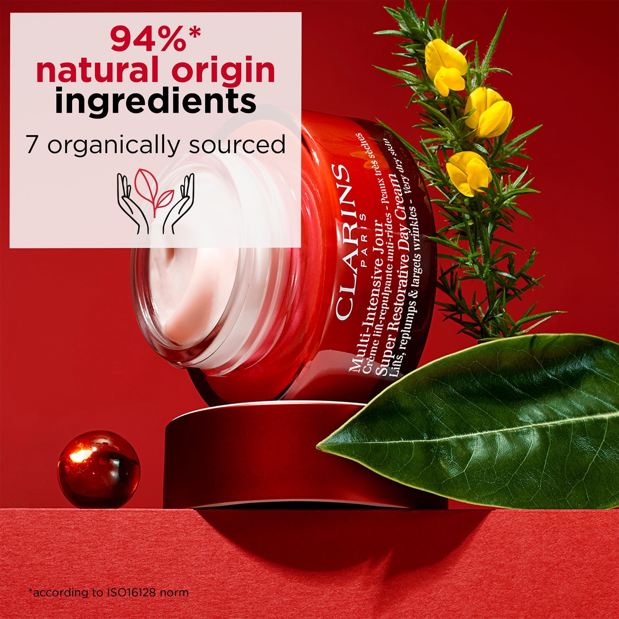 Vasetto rosso con crema. Testo: Clarins, Multi-Intensive Jour, Super Restorative Day Cream.