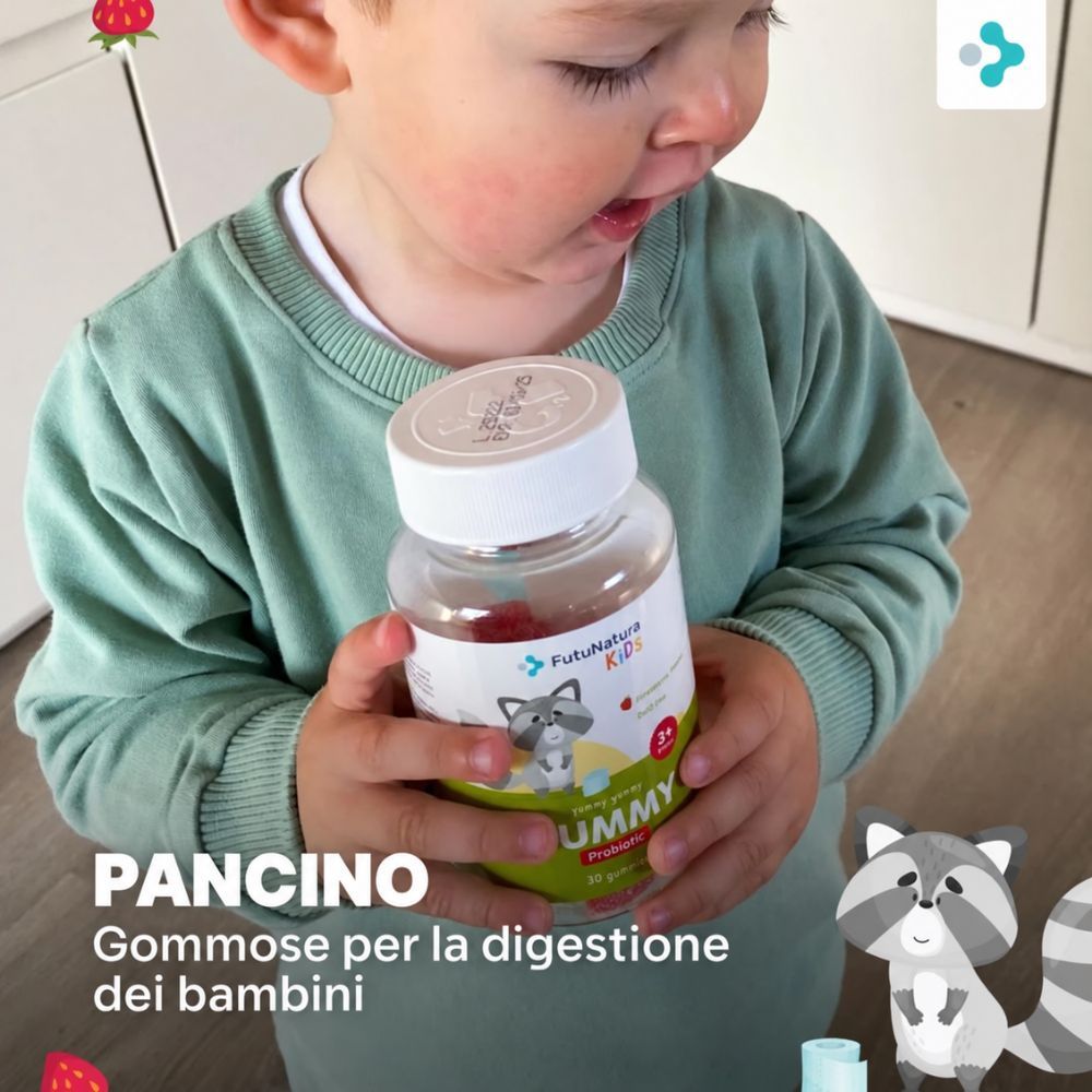 Bambino tiene flacone di gommose FutuNatura Tummy per la digestione. "Pancino" sull'etichetta.