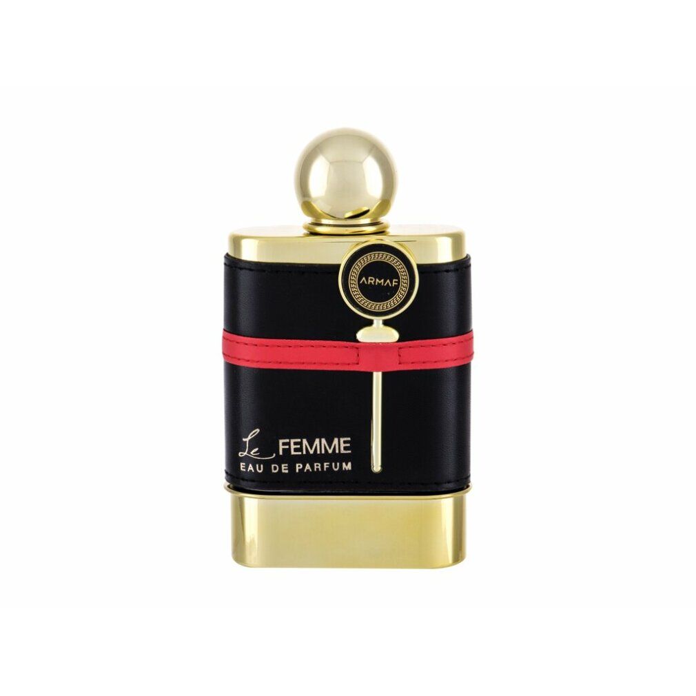 Flacone dorato con fascia in pelle nera e striscia rossa. Scritta: Le Femme Eau de Parfum. Tappo dorato.
