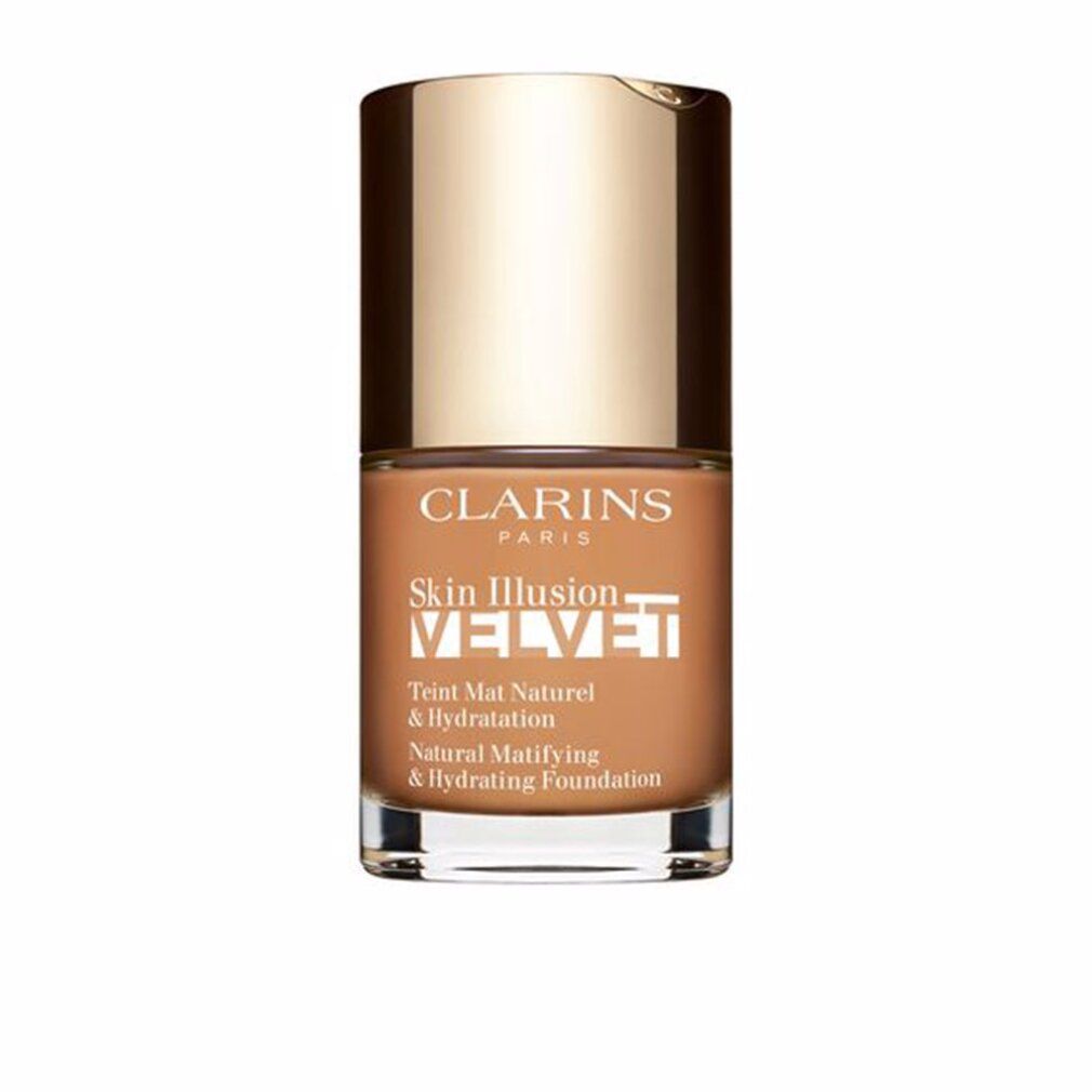 Flacone di fondotinta. Marchio Clarins. Skin Illusion Velvet. Tappo dorato, liquido marrone. Testo: Natural Matifying & Hydrating Foundation.