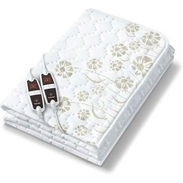 Coperta termica piegata con motivo floreale. Due comandi con display. Logo Beurer.