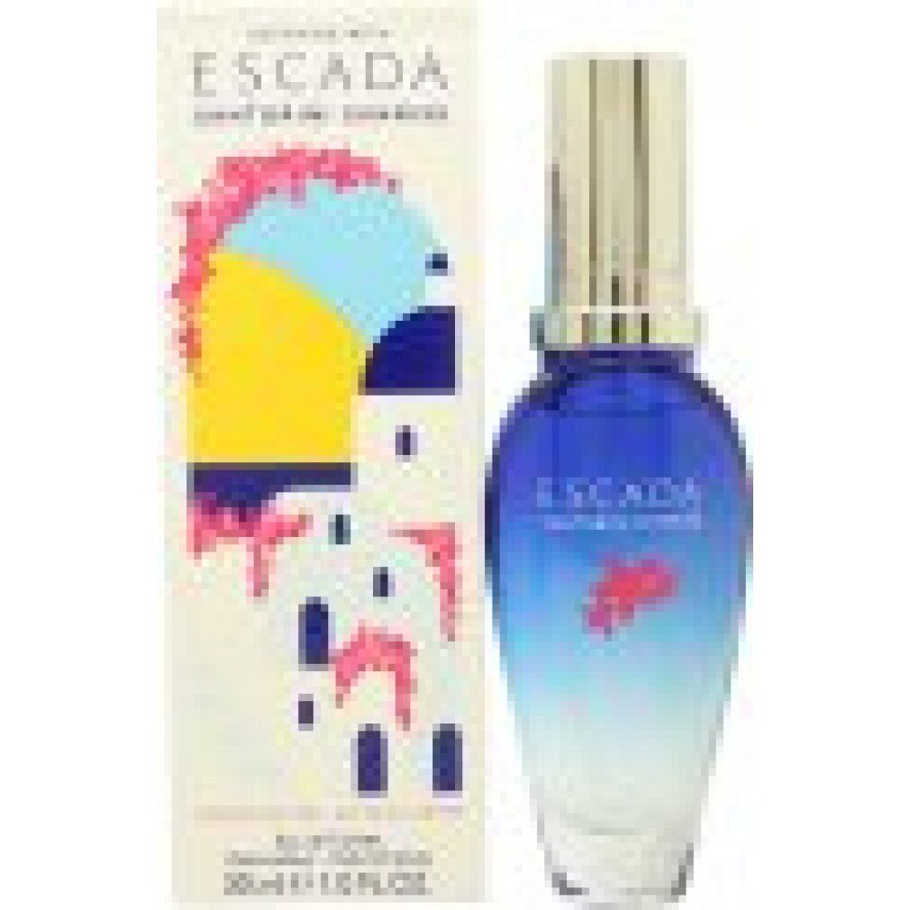 Flacone blu trasparente con tappo argentato e scatola. Nome del prodotto e illustrazione sulla scatola.