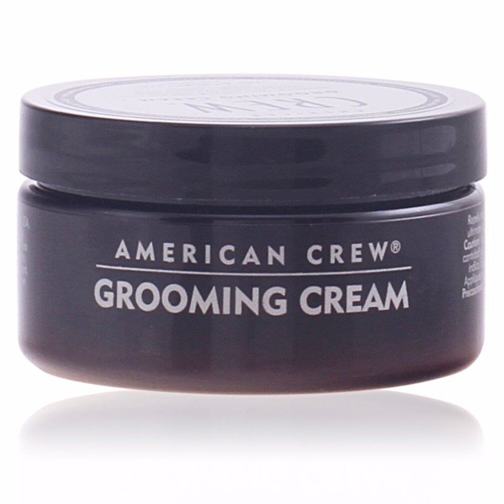 Barattolo nero American Crew Grooming Cream. Testo bianco sul contenitore. Coperchio con logo.