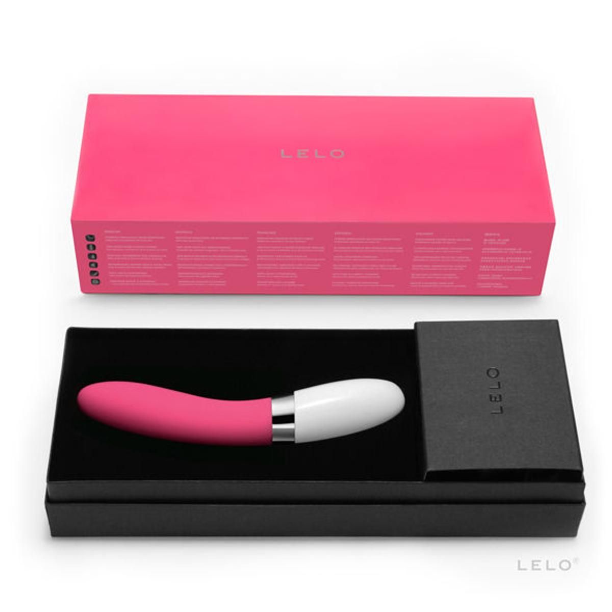 Vibratore rosa e bianco in una scatola nera. La confezione è rosa e riporta il marchio LELO.