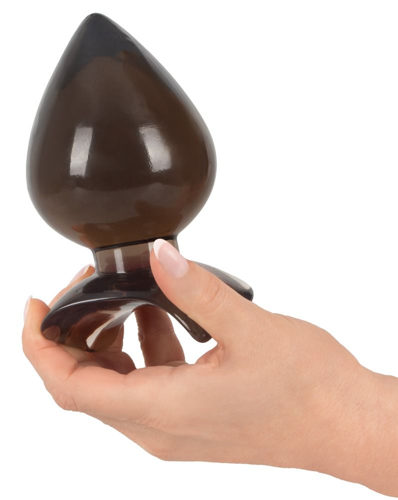 Anal plug, marrone sfumato, a forma di goccia. Punta e base più scure. Superficie liscia. Tenuto in mano. Base ampia.