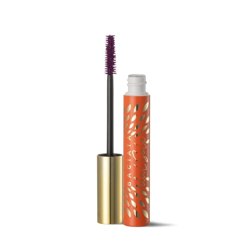 Mascara con spazzola viola e astuccio arancione con dettagli dorati. L'applicatore del mascara è aperto.
