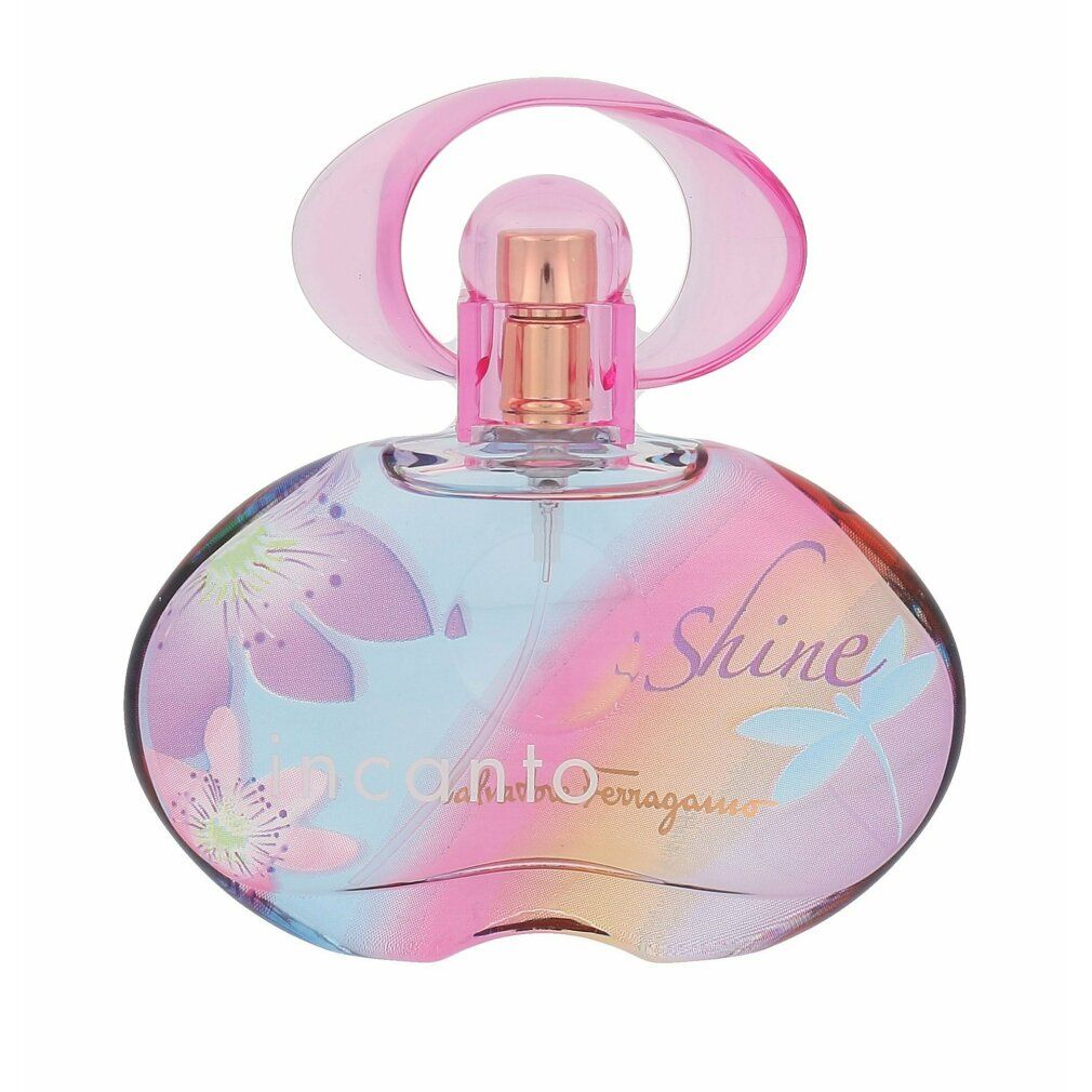 Flacone di profumo rotondo con tappo rosa. Stampa di fiori e scritta: Incanto Shine. Vaporizzatore dorato.