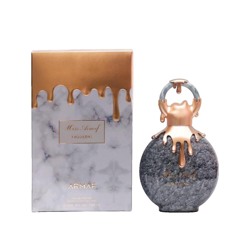 Flacone e scatola di profumo. Flacone rotondo, grigio marmorizzato, elementi dorati. Scatola marmorizzata, parte superiore dorata. Scritta: Miss Armaf Dazzling.