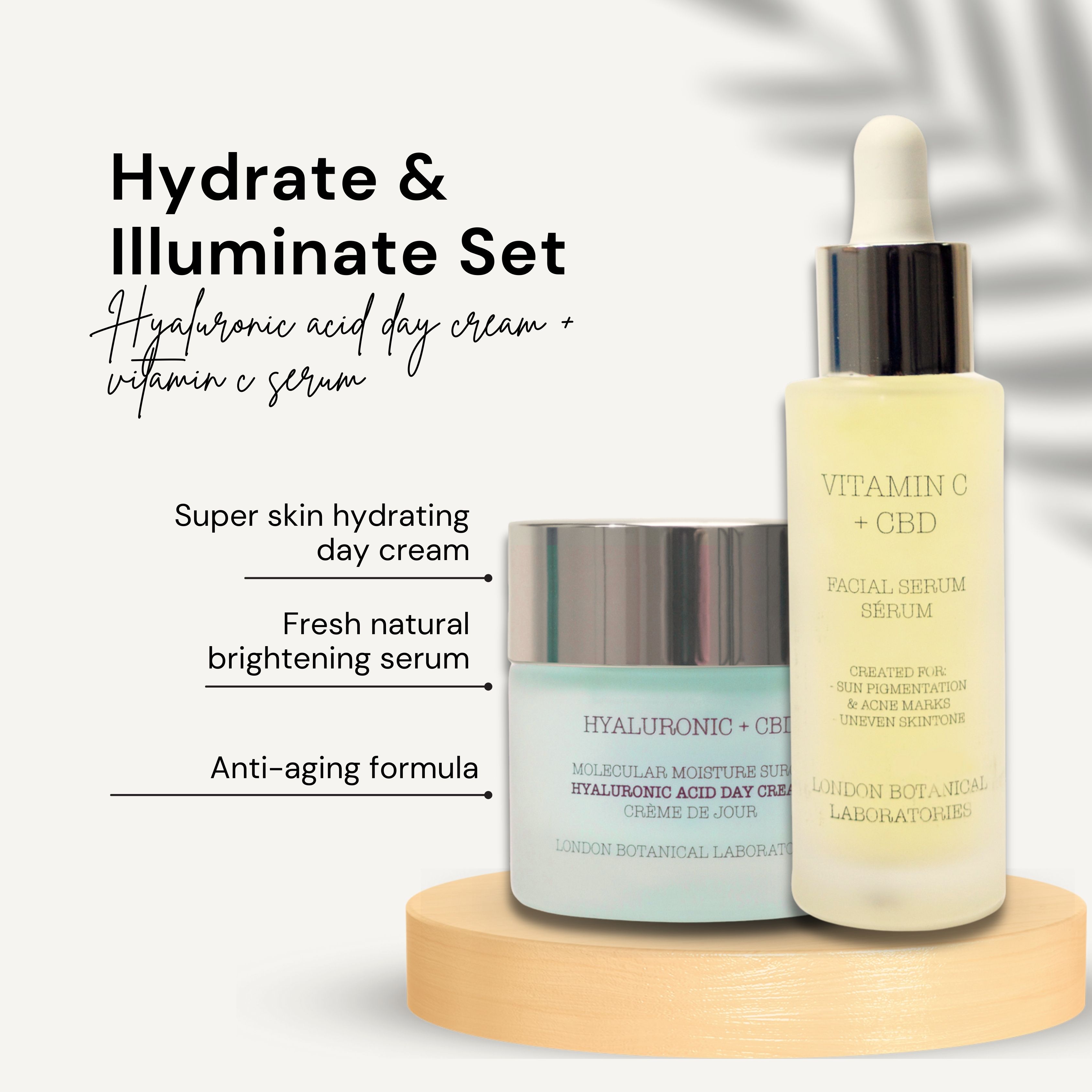 Crema e siero su base in legno. Scritte: Hyaluronic + CBD, Vitamin C + CBD. Testo: Hydrate & Illuminate Set.