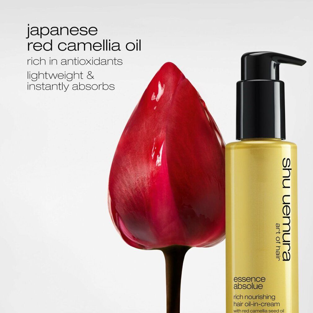 Flacone dorato con erogatore nero e fiore rosso. Scritta: Shu Uemura, Essence Absolue.