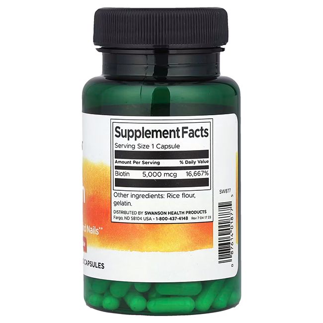 Capsule verdi in flacone verde. Scritta: SWANSON. Informazioni nutrizionali: Biotina 5.000 mcg. Ingredienti: farina di riso, gelatina.
