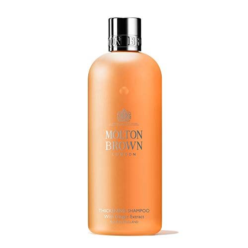 Flacone di shampoo arancione con tappo argentato. Scritta: Molton Brown London, Thickening Shampoo with Ginger Extract.