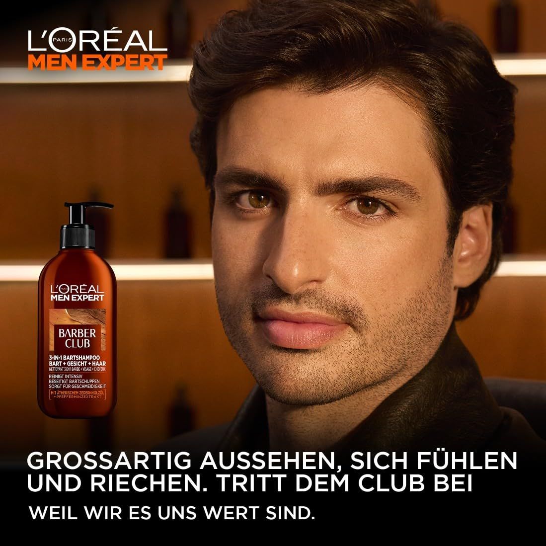 Uomo con barba tiene flacone di shampoo. Scritta L'Oréal Men Expert Barber Club. Testo: Apparire, sentirsi e odorare alla grande.