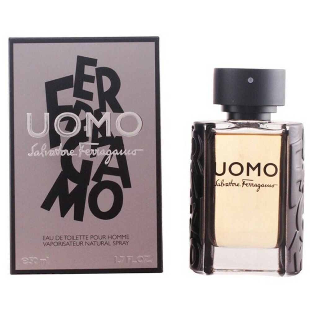 Flacone di profumo con tappo nero e liquido dorato. Scritto: UOMO Salvatore Ferragamo. 1.7 fl oz.