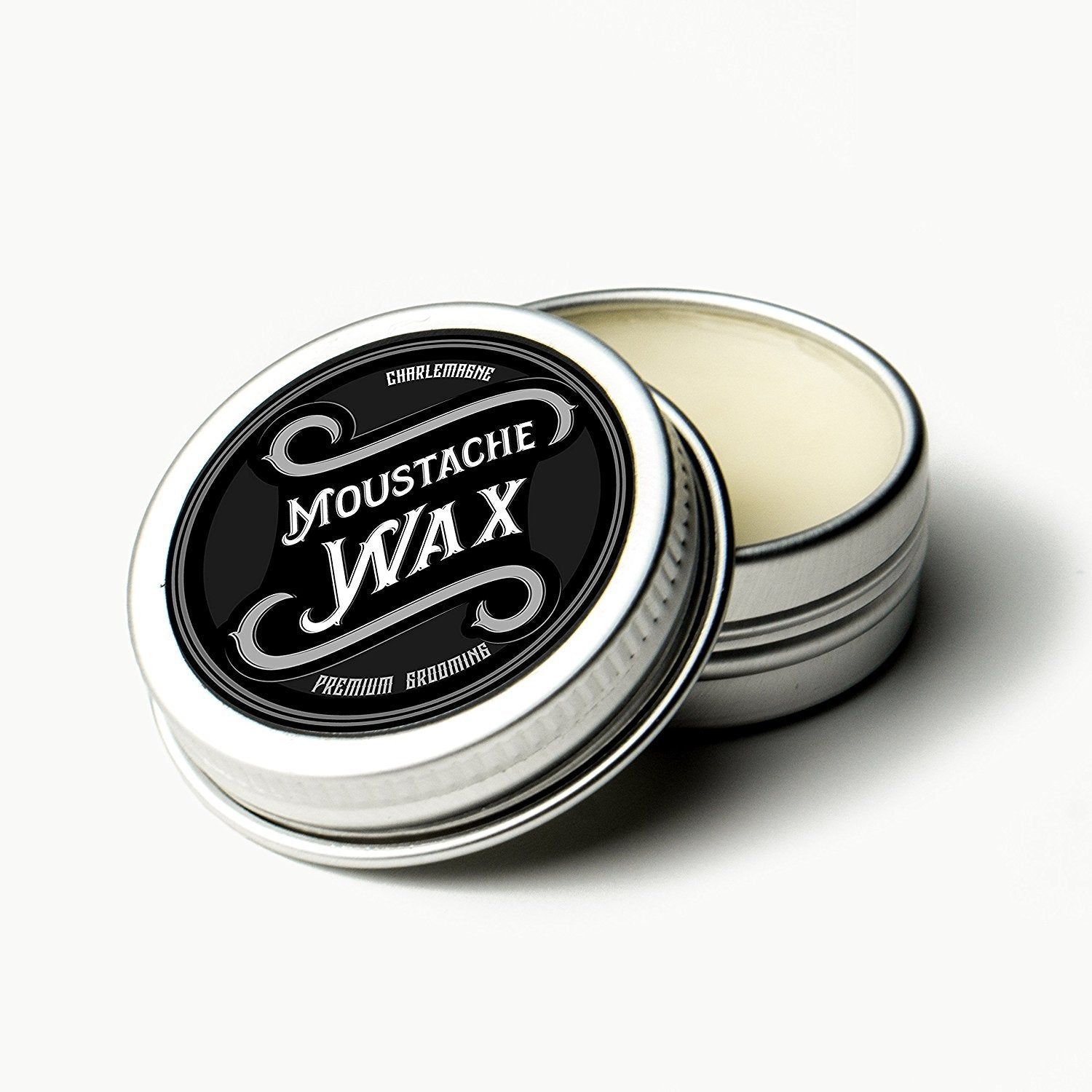 Scatola nera chiusa di cera per baffi CHARLEMAGNE, etichetta "MOUSTACHE WAX".