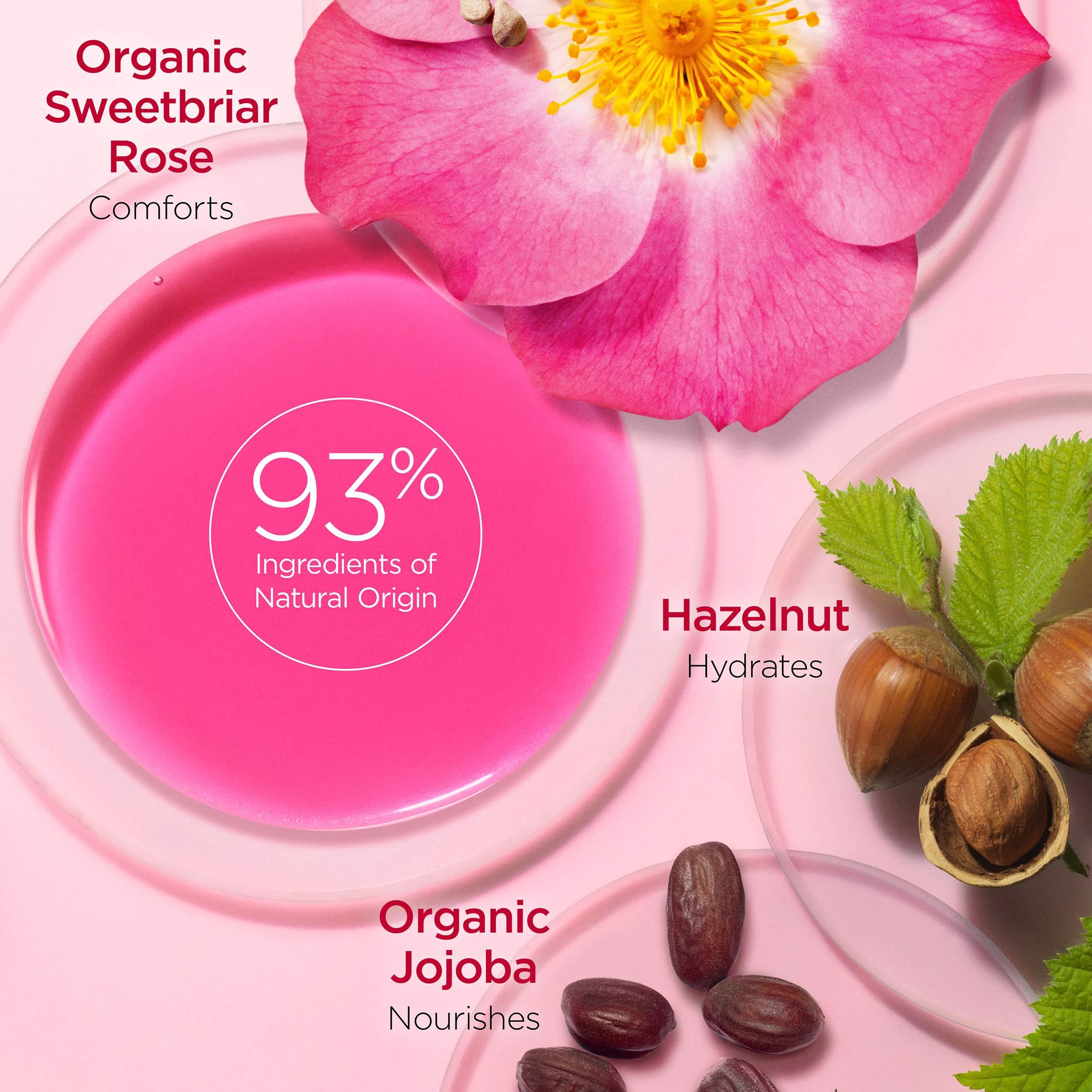 Liquido rosa con testo: 93% ingredienti di origine naturale. Illustrati: rosa, nocciola, jojoba.