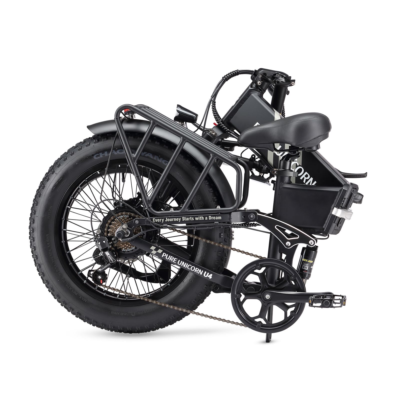 E-bike nera piegata, pneumatici larghi. Marchio PURE UNICORN. Portapacchi e sella.