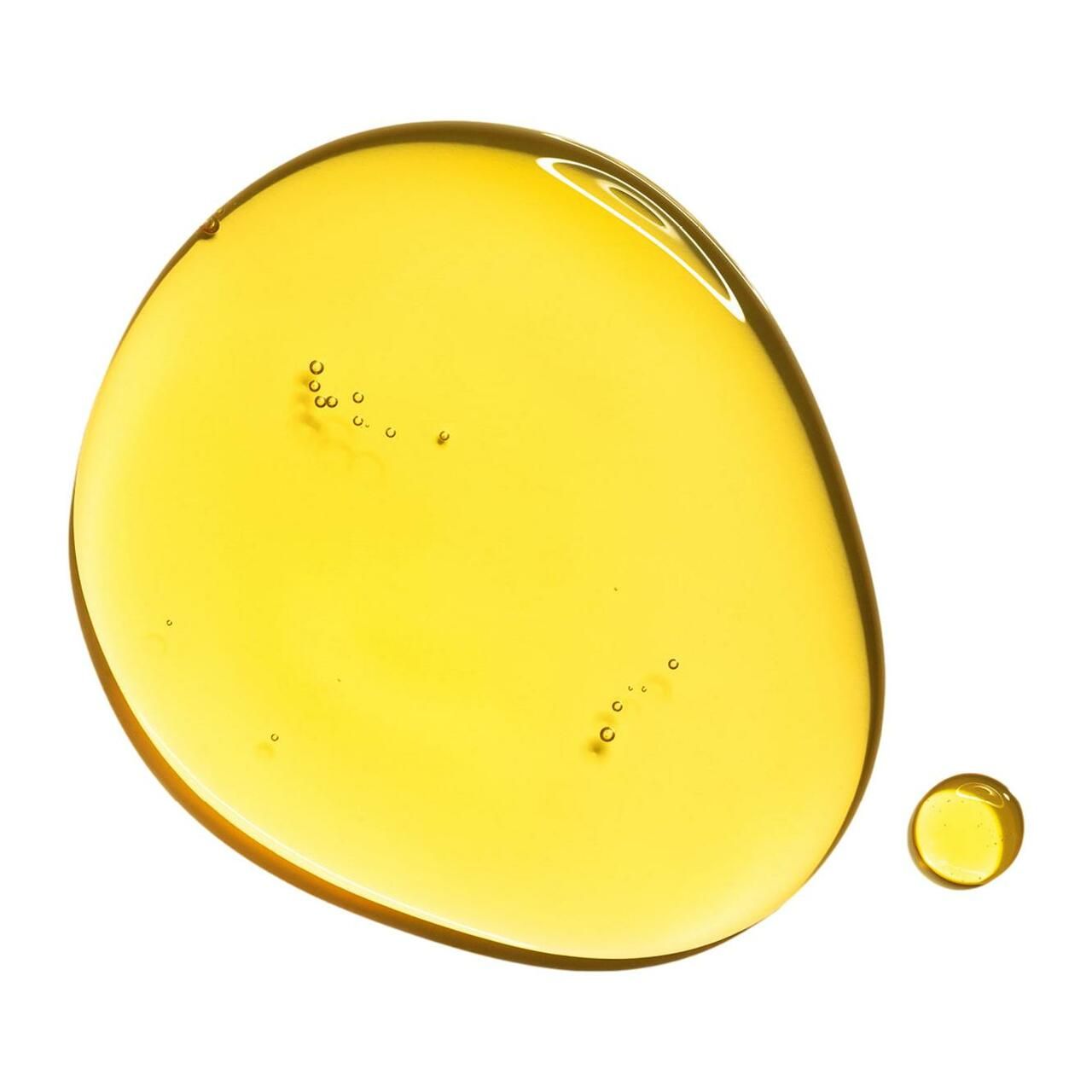 Gocce di liquido giallastro su sfondo bianco. Una goccia grande e una più piccola.