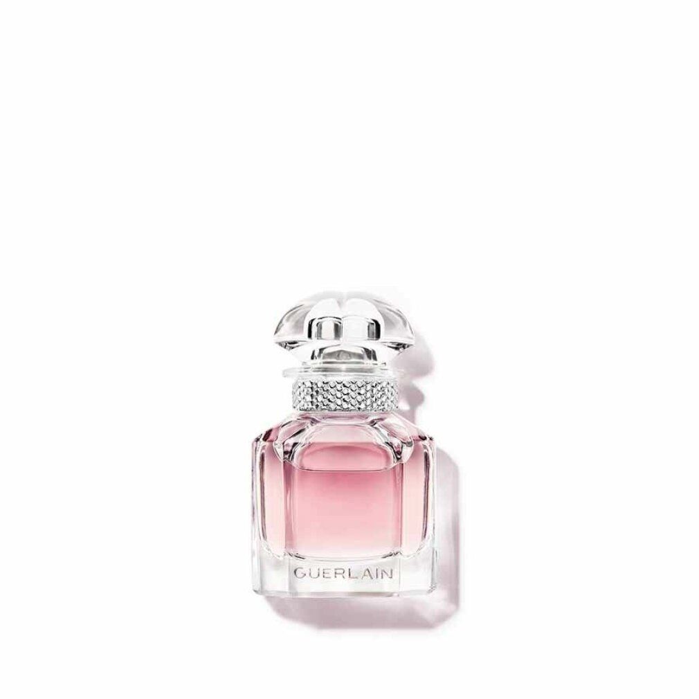 Flacone in vetro con liquido rosa. Tappo trasparente. Anello argentato attorno al collo. "GUERLAIN" in basso.