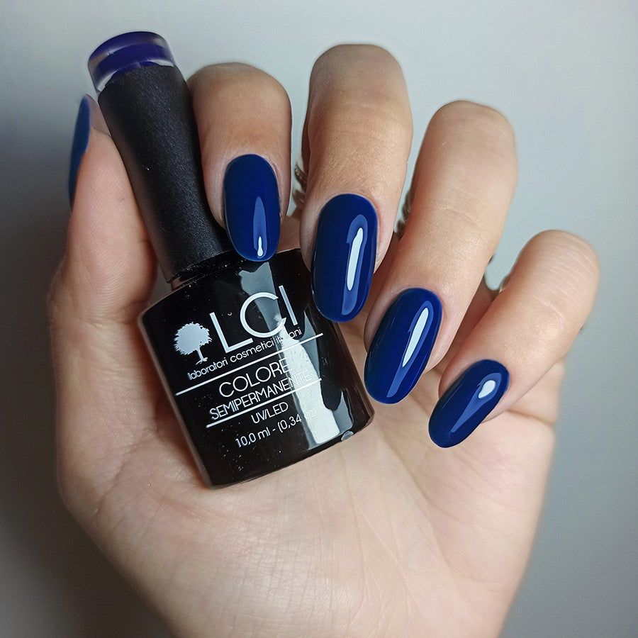 Mano con unghie smaltate e flacone di smalto. Scritta: LCI, Colore Semipermanente, UV/LED 10,0 ml.