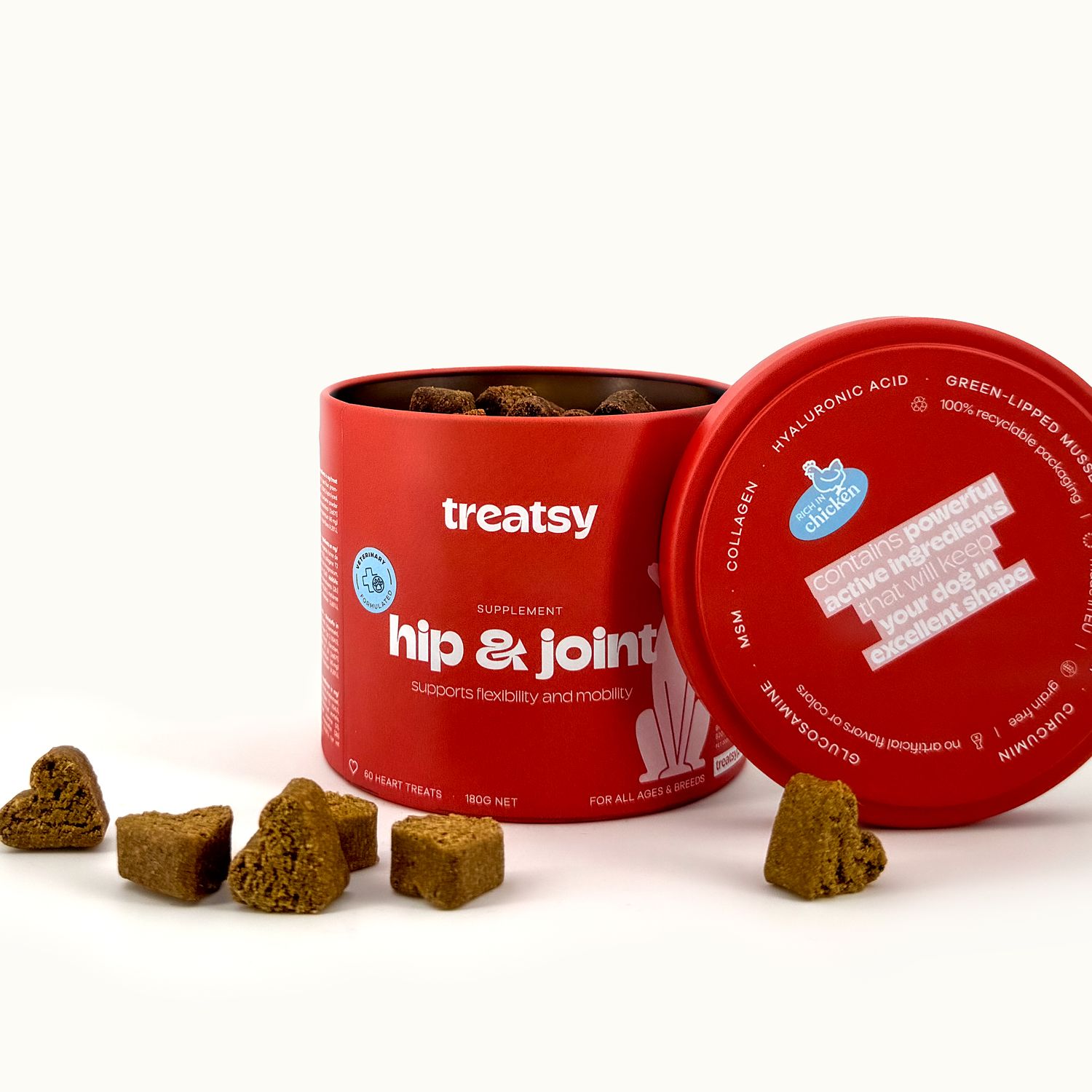 Barattolo rosso "Treatsy" con "hip & joint". Coperchio aperto, snack visibili. Testo sul coperchio.