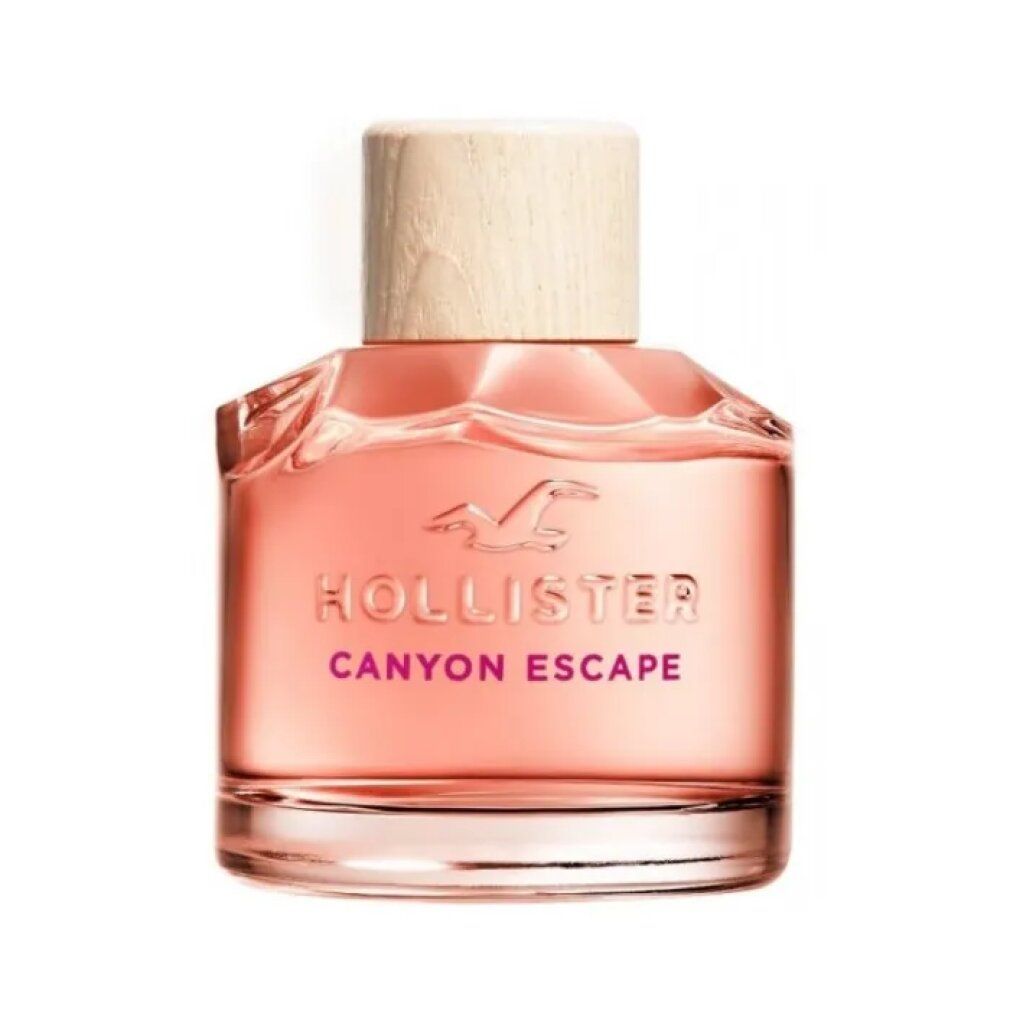 Flacone di profumo con tappo in legno. Scritta: Hollister Canyon Escape. Liquido rosa in un flacone quadrato di vetro.