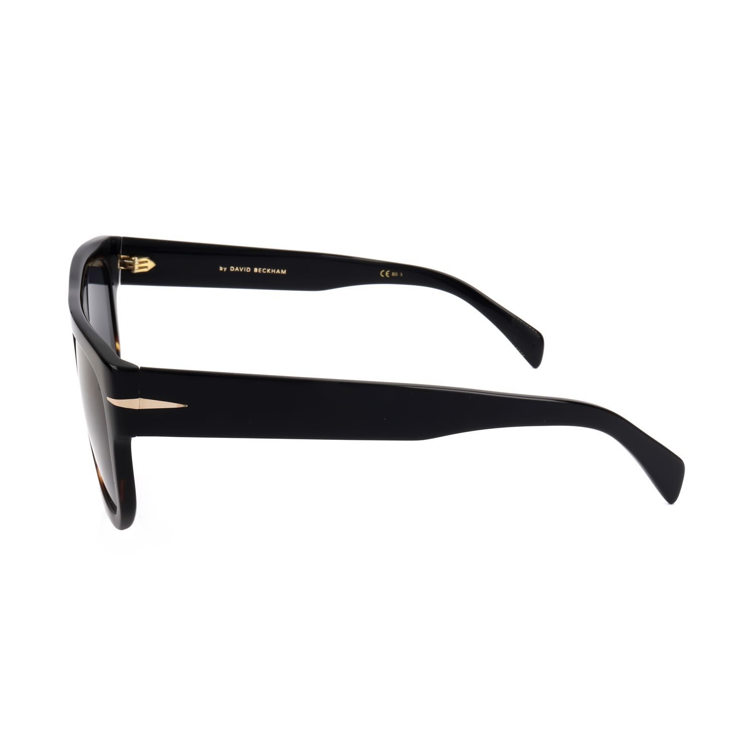 Occhiali da sole neri in profilo laterale con accenti dorati e scritta 'BY DAVID BECKHAM'.