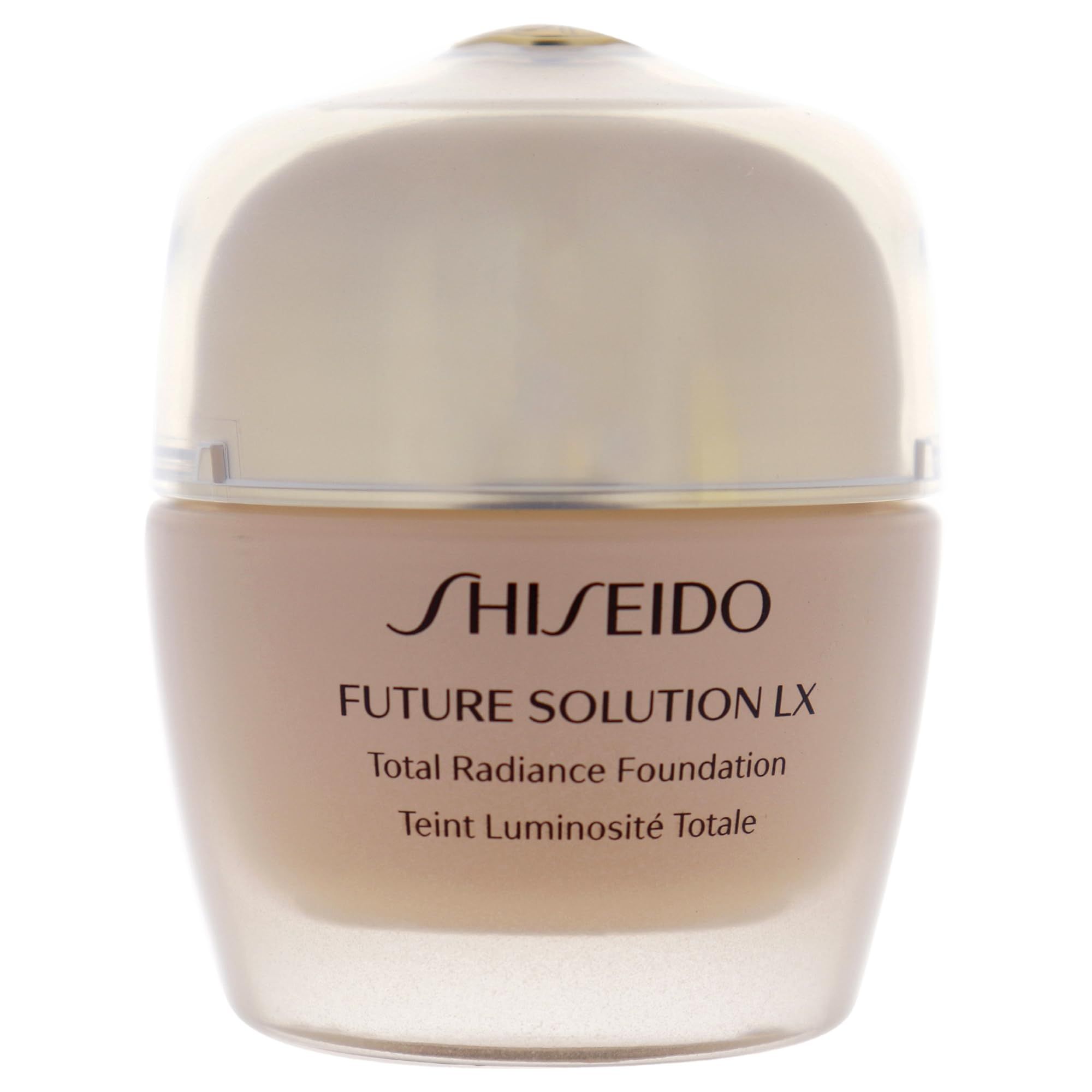Flacone di fondotinta beige con coperchio trasparente. Scritta Shiseido, Future Solution LX, Total Radiance Foundation.
