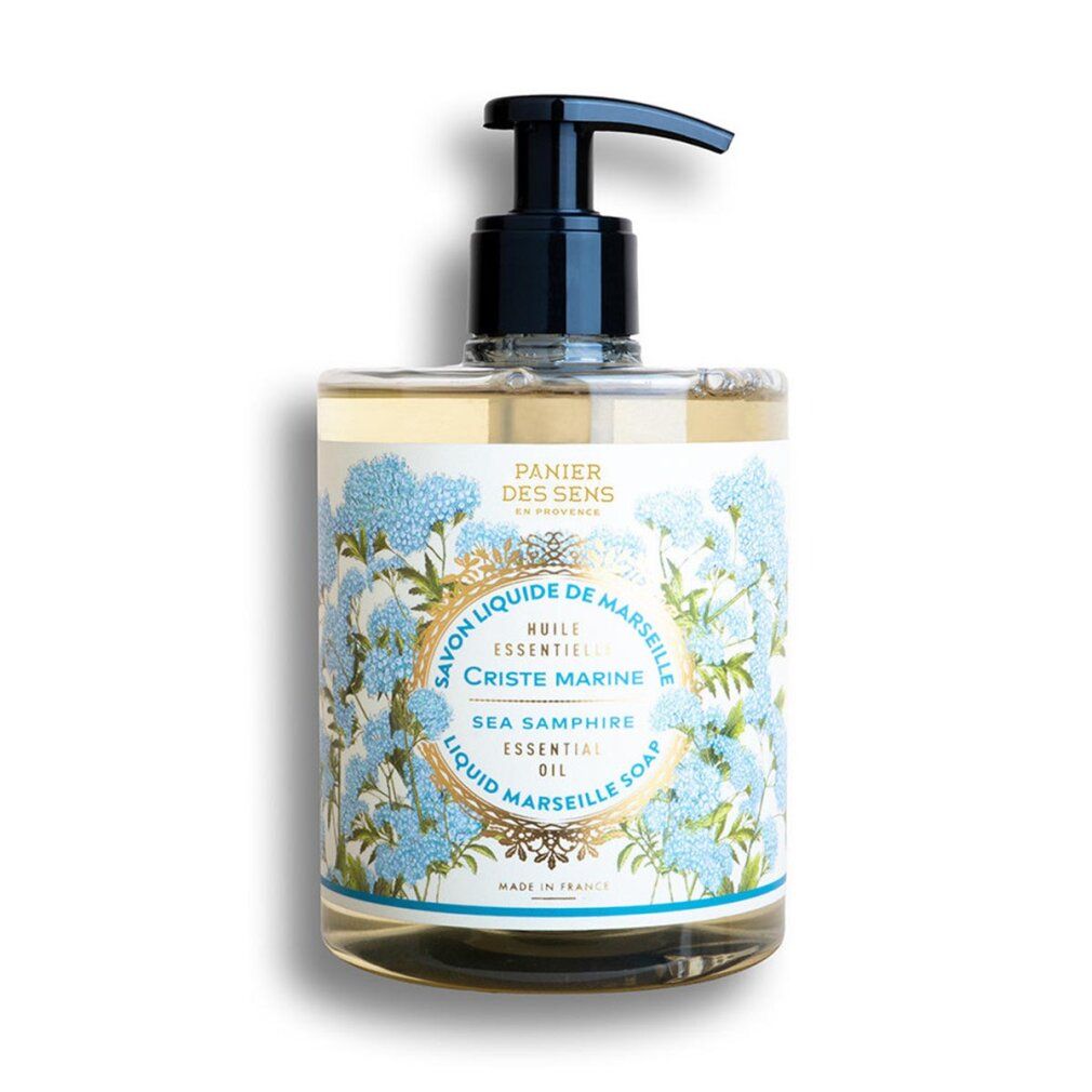 Sapone liquido in flacone rettangolare con dosatore nero. Etichetta floreale con nome del prodotto e indicazioni.