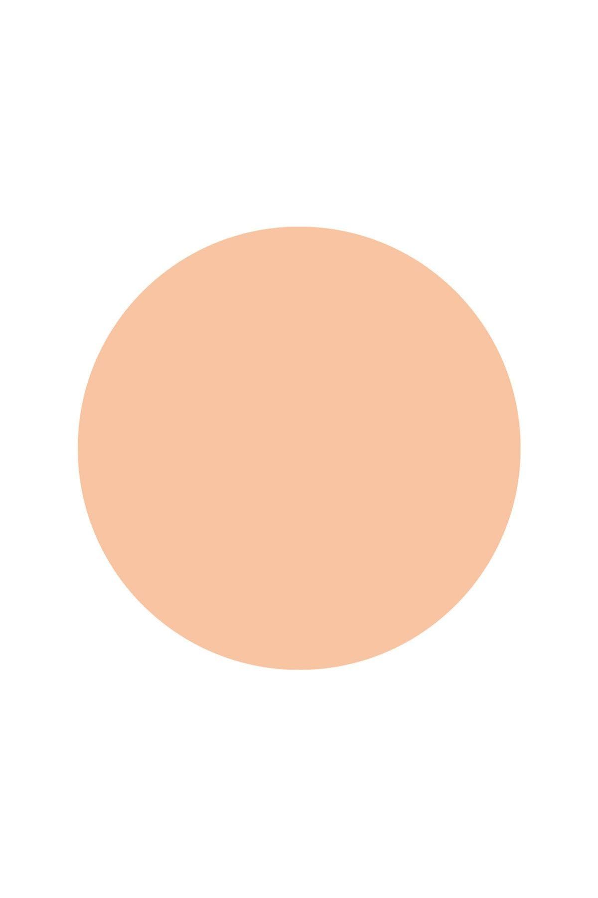 Macchia rotonda di colore crema chiaro su sfondo bianco.