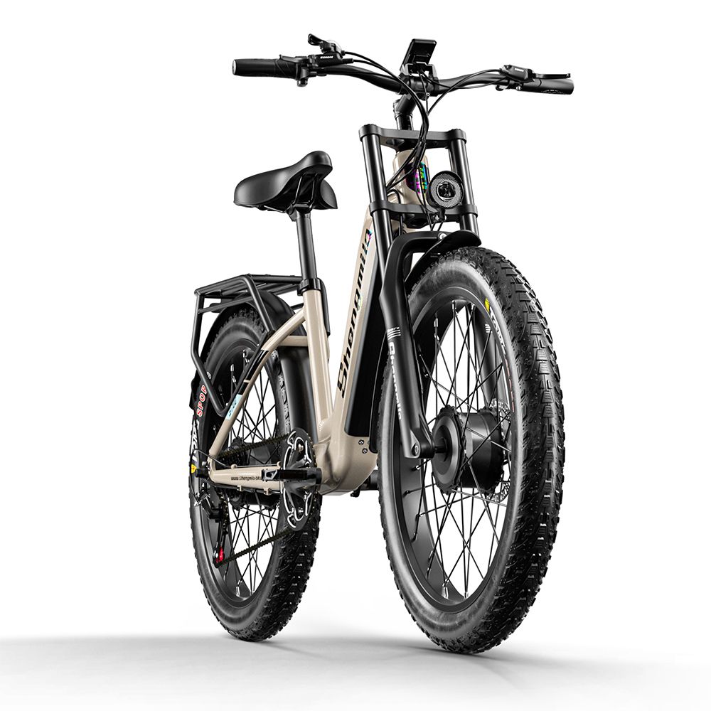 E-bike, vista frontale. Telaio beige, pneumatici neri. Marchio Shengmilo visibile. Faro anteriore e sospensioni.