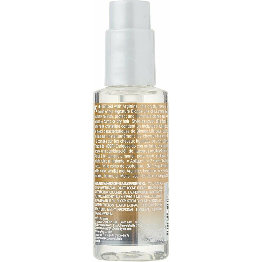 Retro di una bottiglia di olio per capelli. Testo con ingredienti e informazioni. Olio trasparente visibile.