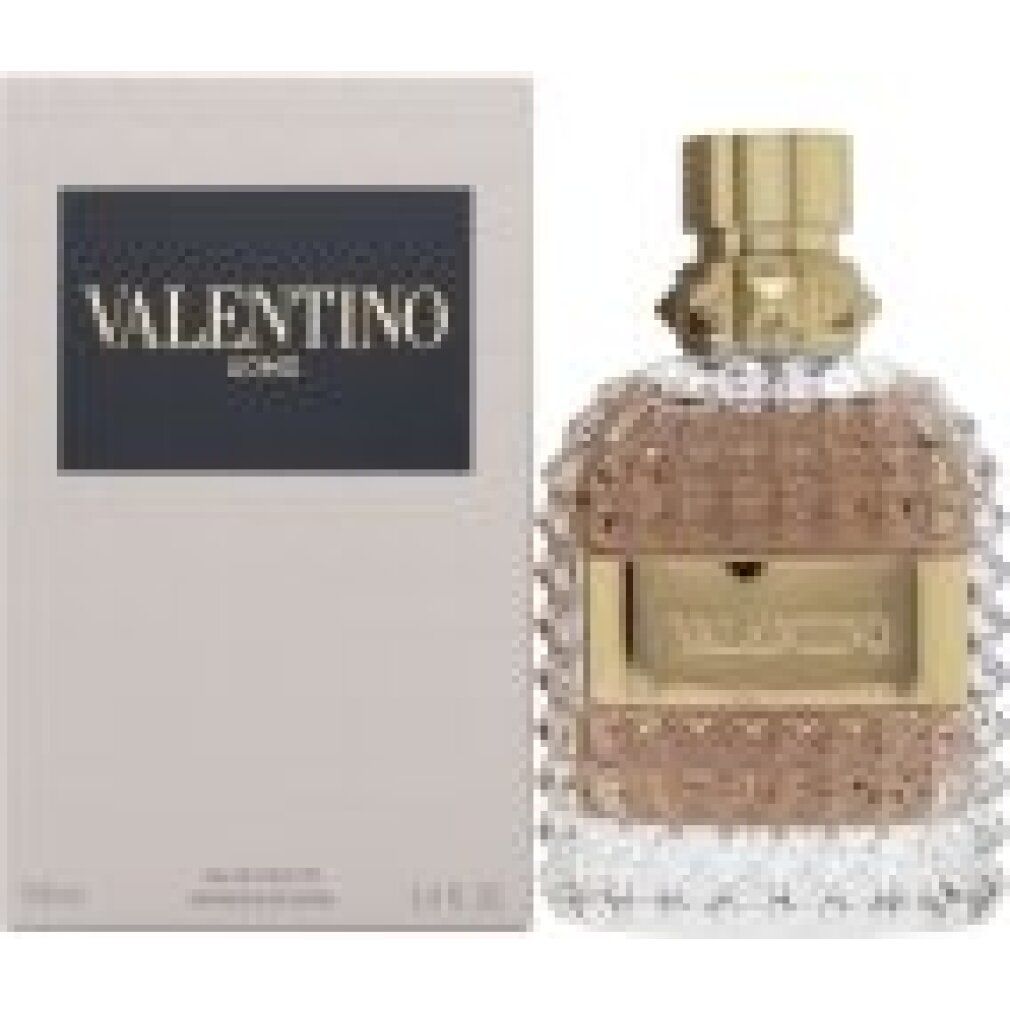 Flacone di profumo e confezione. Flacone con tappo ed etichetta dorati. Confezione con logo.