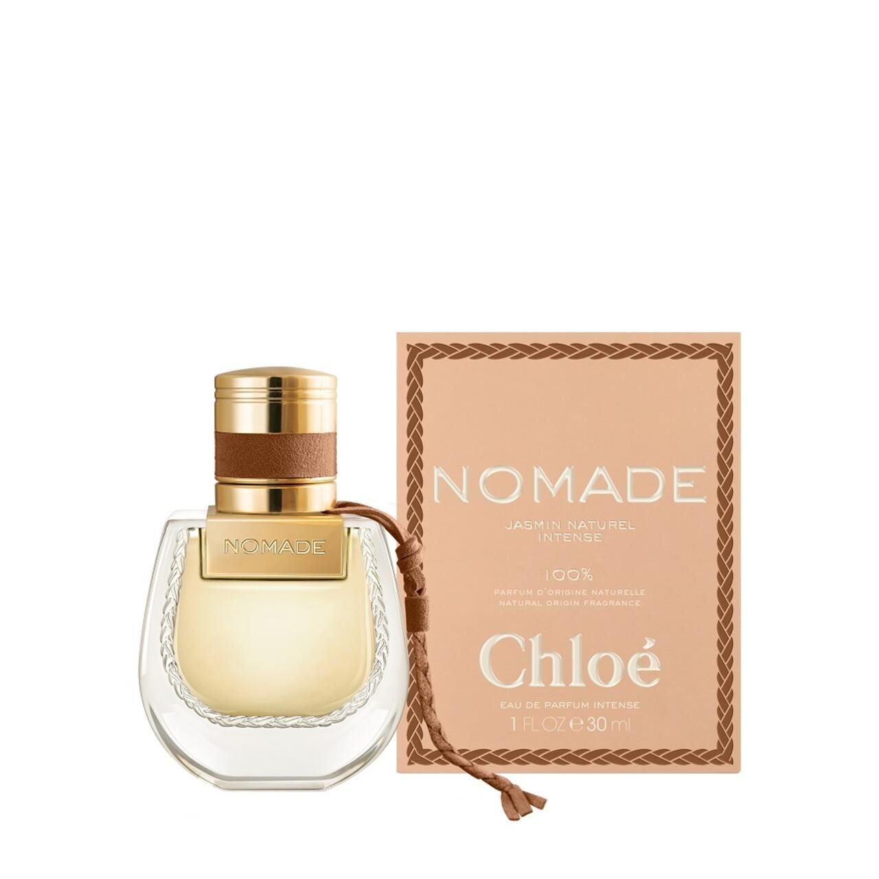 Flacone di profumo e confezione. Flacone con tappo dorato. Confezione con scritta NOMADE.