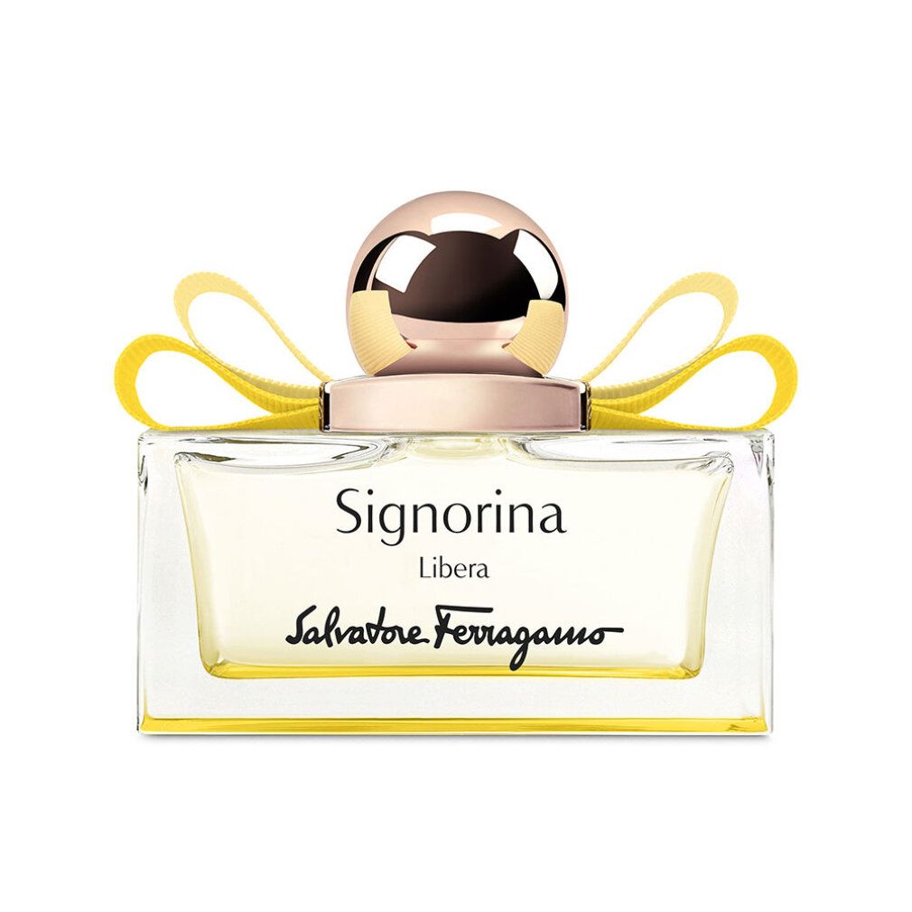 Flacone in vetro con liquido giallo, tappo dorato e fiocco giallo. Scritta Signorina Libera e Salvatore Ferragamo.