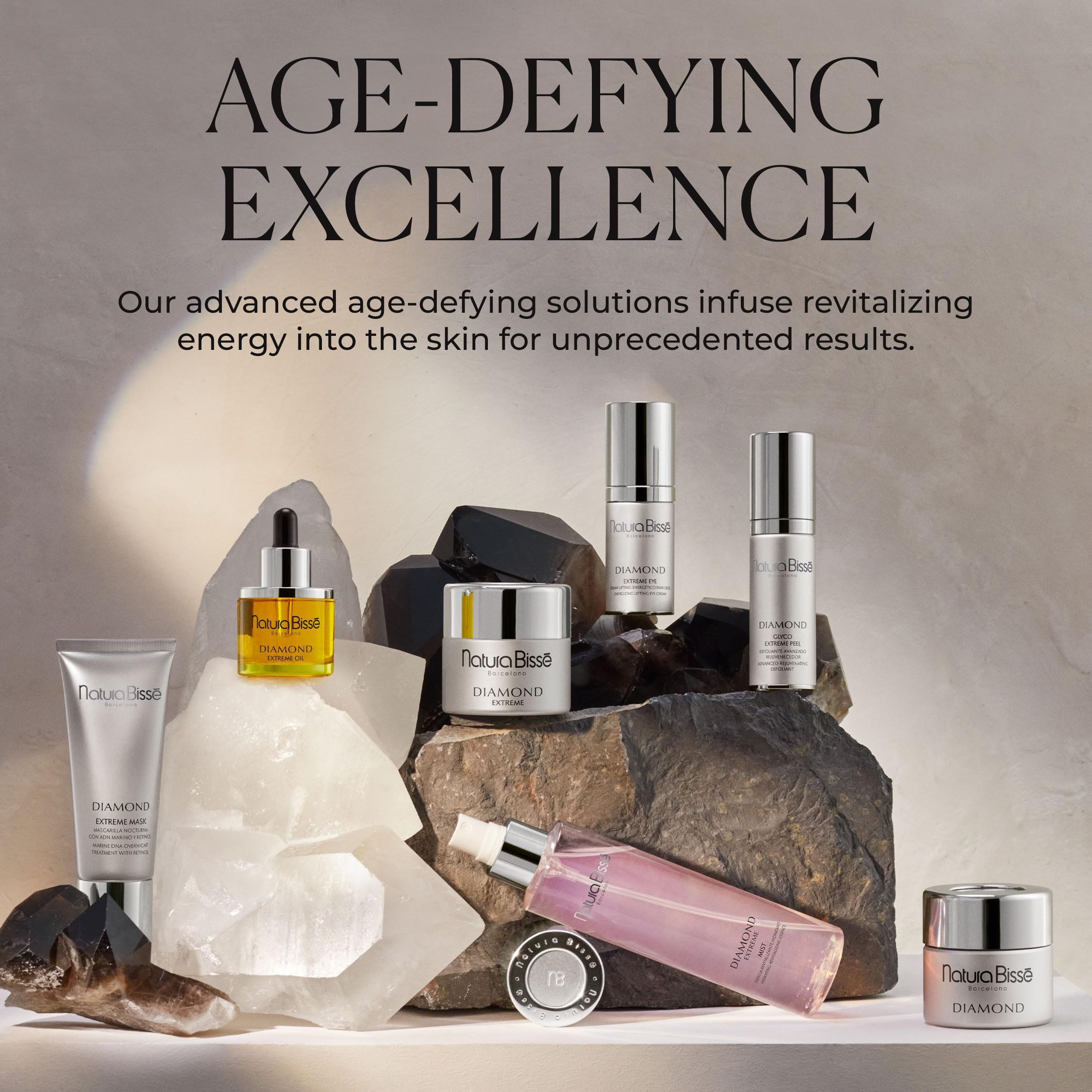 Vari prodotti cosmetici su pietre. Testo: Age-Defying Excellence, Natura Bissé, Diamond. Varie bottiglie e vasetti.