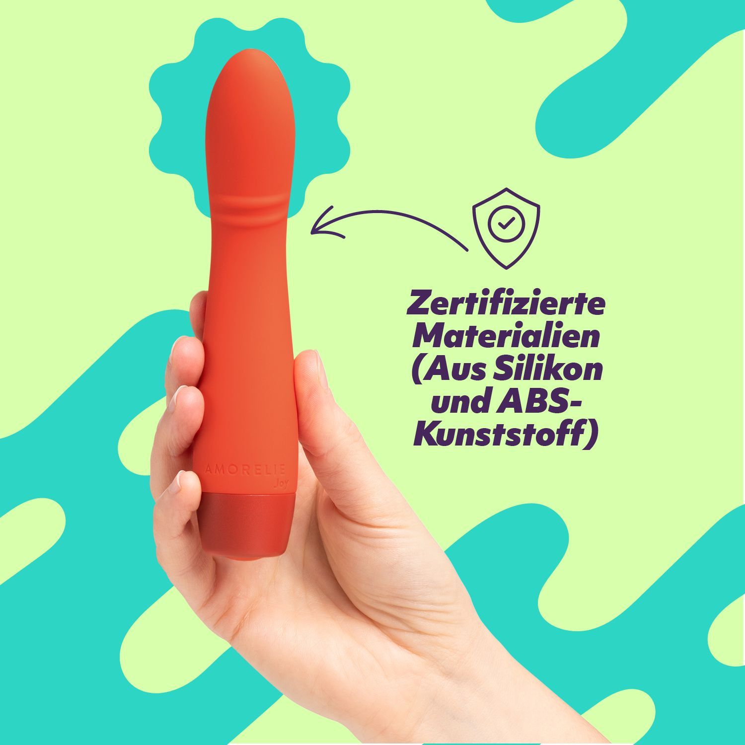 Vibratore rosso in mano. Testo: Materiali certificati (in silicone e plastica ABS).