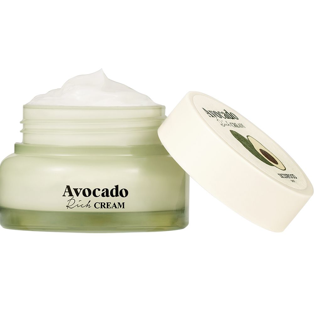 Vasetto di crema aperto con coperchio bianco accanto. Scritta "Avocado Rich CREAM". Crema visibile.