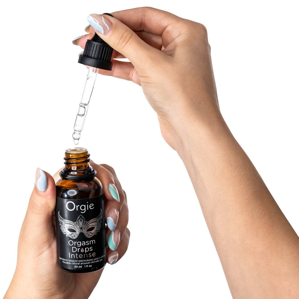 Mani che tengono un flacone di vetro ambrato con contagocce nero. Scritta: Orgie, Orgasm Drops Intense.