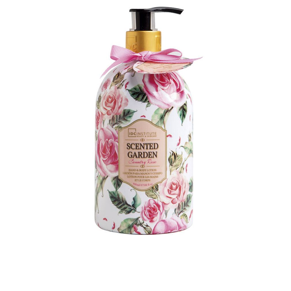 Flacone con motivo floreale e dosatore. Scritta: Scented Garden, Rose. Fiocco rosa ed etichetta.