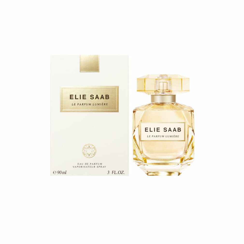 Elie Saab Le Parfum Lumiere Edp Spray e confezione. Scatola bianca, logo dorato e flacone.