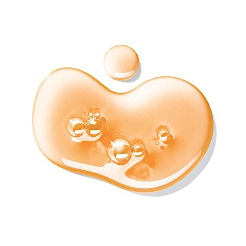 Goccia di texture gel arancione con bolle d'aria su sfondo bianco.